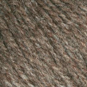 Close-up of Bartlettyarns Maine Wool Yarn, displaying tightly woven fibers with heathered colors of light and dark brown strands. The material appears coarse with visible individual threads, creating a dense and earthy pattern that echoes the rustic charm of this Bartlettyarns product.