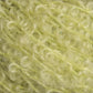 Close-up of a textured, fuzzy yellow material with curly fibers interwoven. The surface appears soft and intricate, with loops and waves creating a complex yet cozy appearance. This piece from Caledonian Dye Works' Victorian Bouclé Mohair Yarn collection showcases a bright, pale yellow that exudes timeless elegance.