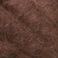 Close-up image of a Victorian Brushed Mohair Yarn Mini Skein from Caledonian Dye Works, featuring a rich, fuzzy texture. The intertwined natural fibers create a luxurious appearance with warm brown shades for a variegated look reminiscent of mohair.