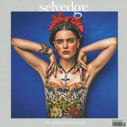 The cover of Selvedge Issue 109: Rise Up from the brand Selvedge showcases model Claudia Muñoz Morales with braided hair adorned with a red headpiece. She wears a colorful, floral-patterned dress, multiple bracelets, and necklaces while striking a pose against a blue background. The tagline reads "The Fabric of Your Life.