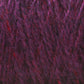 Close-up of purple and red variegated Harrisville Designs Shetland Yarn - Unwashed Cones. The fibers intertwine in a textured pattern, showcasing a mix of rich, vibrant shades. The yarn appears thick and soft, highlighting its fluffy, wool-like texture ideal for Fair Isle knitting designs.