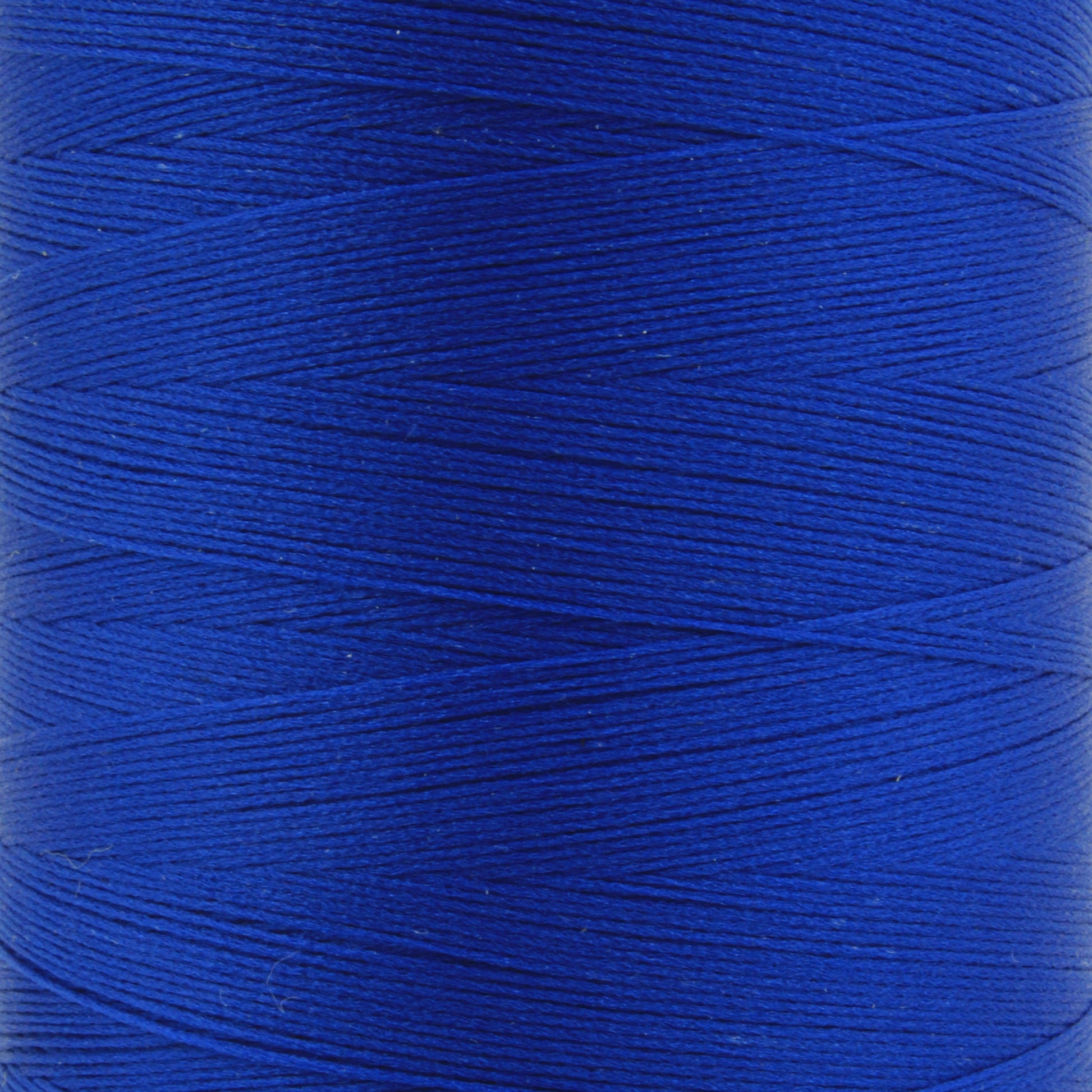 A close-up image of a spool of vibrant blue Woolly Nylon Reinforcement Yarn by YLI Corp. The yarn is wound tightly around the spool, showcasing its smooth texture and vivid color. The image highlights the detailed, fine lines of the yarn, giving a sense of its quality and strength—perfect for crafting durable socks.