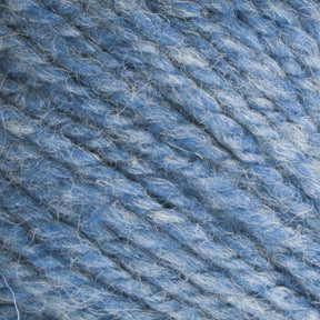 Close-up image of Bartlettyarns Maine Wool Yarn in blue, featuring heathered colors with various light and dark blue strands interwoven, showcasing its fluffy texture and twisted fibers.