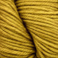 Close-up image of thick, twisted Malabrigo Rios yarn in mustard yellow, showcasing the texture of the fibers and the spiral pattern of the twist. The yarn appears soft and slightly fuzzy, with kettle-dyed colors suitable for knitting or crocheting by Malabrigo Yarn.