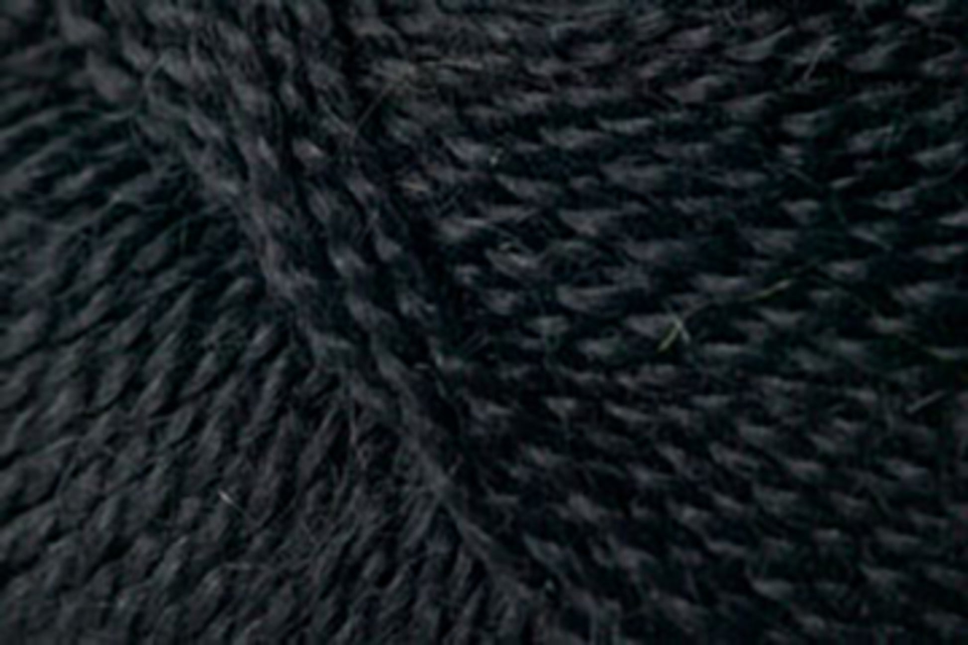 Close-up image of tightly woven, dark-colored Jo Sharp Alpaca Kid Lustre fibers by Kingfisher Yarn & Fibre intertwined to create a rich texture. The yarn appears thick and robust, showcasing individual strands that are neatly twisted together, suitable for knitting or crocheting.