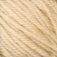 Close-up image of a bundle of Halcyon Deco Rug Wool from Caledonian Dye Works. The soft, cream-colored yarn has a slightly fuzzy texture. Made from 100% wool, it is tightly wound, showcasing the individual strands and fibers intertwined together.