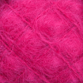 A close-up view of a ball of fuzzy, bright pink Victorian Brushed Mohair Yarn | Mini Skein by Caledonian Dye Works. The fibers are soft and wispy, creating a vibrant and textured appearance. Made from luxurious mohair, the shades of pink vary slightly, giving depth to the yarn's color.