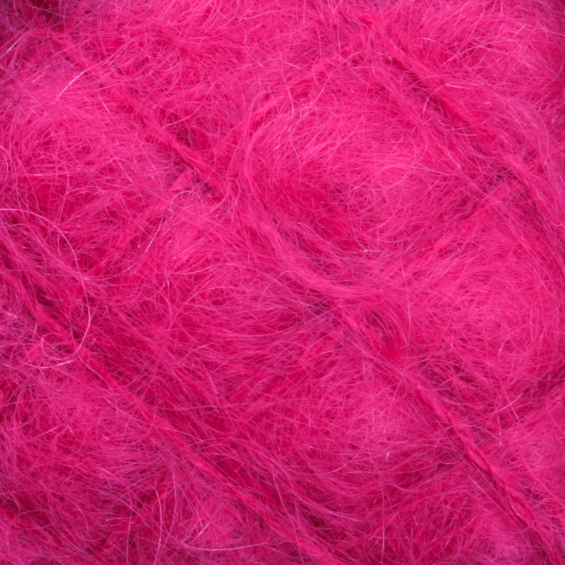 A close-up view of a ball of fuzzy, bright pink Victorian Brushed Mohair Yarn | Mini Skein by Caledonian Dye Works. The fibers are soft and wispy, creating a vibrant and textured appearance. Made from luxurious mohair, the shades of pink vary slightly, giving depth to the yarn's color.