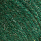 Close-up image of green woolen yarn showcasing its fibrous texture and intricate strands. The slight color variations and heathered colors of this worsted weight yarn capture the natural look of the material, perfectly exemplifying Bartlettyarns Maine Wool Yarn by Bartlettyarns.