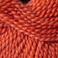 A close-up view of tightly wound, warm-colored orange yarn. The fibers are thick and intricately twisted, showcasing the texture and detail of the threads. This Jo Sharp Alpaca Kid Lustre DK gauge yarn by Kingfisher Yarn & Fibre appears soft and suitable for knitting or crocheting projects.