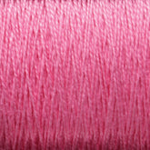 Close-up view of Supreme Corp.'s 10/2 Pearl Cotton Yarn | Mini-cone in pink, wound tightly around a spool, showing detailed texture and fibrous strands. The image highlights the soft and slightly glossy appearance of this versatile yarn, renowned for its colorfastness.