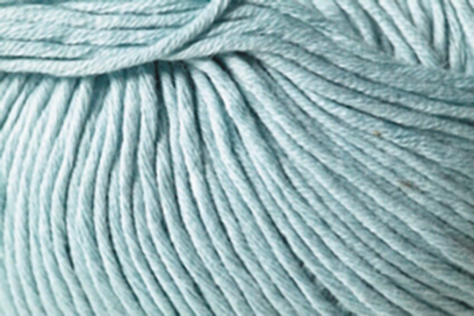 Close-up image of light blue Jo Sharp Soho Summer DK Cotton by Kingfisher Yarn & Fibre, showcasing individual strands and fibers woven together. The texture appears soft and smooth, making it ideal for knitting or crocheting summer projects.