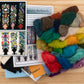 A wooden surface showcases vibrant wool strands beside a "Needle Felting Tapestry Kit" from The Felting Studio, featuring intricate bookmark designs adorned with floral patterns. An inset on the left provides close-ups of completed bookmarks made with variously colored wool tapestries. Detailed needle felting instructions are included to ensure stunning results.