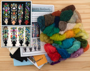 A wooden surface showcases vibrant wool strands beside a "Needle Felting Tapestry Kit" from The Felting Studio, featuring intricate bookmark designs adorned with floral patterns. An inset on the left provides close-ups of completed bookmarks made with variously colored wool tapestries. Detailed needle felting instructions are included to ensure stunning results.