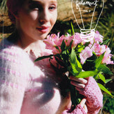 A person in a pink sweater and fingerless gloves holds a bouquet of pink flowers against a backdrop of green foliage. At the top, the text "Filament No. 2" accompanied by a light bulb illustration highlights modern classics, with "Spring 2017" and Knit Filament's web address at the bottom right.