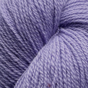 A close-up image of a skein of light purple yarn, showcasing the soft and tightly spun fibers made from Patagonia Organic Merino by Juniper Moon Farm. The texture is clearly visible, with individual strands intertwined to form a smooth and consistent appearance. GOTS certified for quality assurance by Knitting Fever / Euro Yarns.