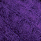 Close-up image of Caledonian Dye Works' Victorian Brushed Mohair Yarn with a soft and fluffy texture. The fibers are entangled, creating a dense and vibrant surface. The image highlights the intricate details reminiscent of Victorian yarns found in this large skein.