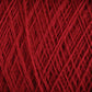 Close-up image of a ball of vibrant red JaggerSpun Maine Line 3/8 Yarn | Mini-cone by Jagger Brothers, Inc., with detailed texture showing the individual strands woven together in a crisscross pattern. The rich, red color is uniform throughout the worsted spun yarns, highlighting the fibrous material.