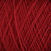 Close-up image of a ball of vibrant red JaggerSpun Maine Line 3/8 Yarn | Mini-cone by Jagger Brothers, Inc., with detailed texture showing the individual strands woven together in a crisscross pattern. The rich, red color is uniform throughout the worsted spun yarns, highlighting the fibrous material.