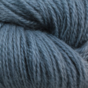 Close-up of the Jade Sapphire Cashmere 2-Ply yarn strands twisted into thick and textured bundles, showing the detailed fibers and patterns of the wool. The hand-dyed light blue colors make this Jade Sapphire Exotic Fibres yarn appear soft and suitable for knitting or crocheting, perfect for woven accessories or finely knit sweaters.