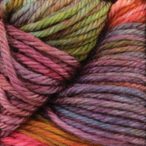 Close-up image of multi-colored yarn intertwined together. The Malabrigo Rios yarn from Malabrigo Yarn features kettle-dyed colors in shades of pink, green, purple, blue, and orange, creating a vibrant and textured pattern.