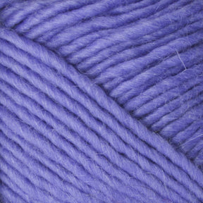 Close-up image of soft, thick, purple Lamb's Pride Worsted Yarn by Brown Sheep. The fibers are tightly wound together, showcasing their smooth and slightly fuzzy texture. The yarn appears plush and suitable for knitting or crocheting cozy projects like Navajo style weaving.