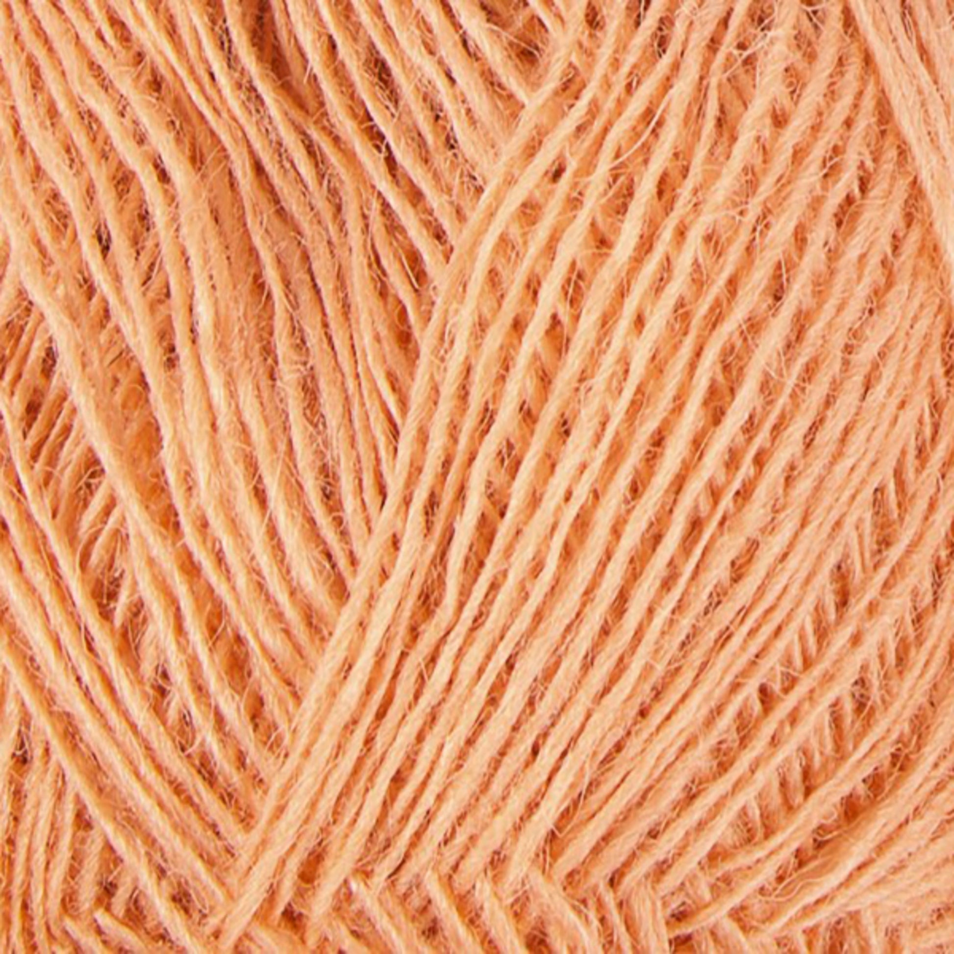 Close-up image of a ball of Einband Lopi, peach-colored yarn from Berroco, Inc., made from Icelandic wool. The tightly wound strands create a textured and intricate pattern ideal for lace knitting. The fibers appear soft and slightly fuzzy.