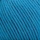 Close-up of bright blue Cotton Fleece from Brown Sheep, tightly wound in a ball. The yarn strands are neatly arranged, showcasing the texture and slight sheen of the fibers. The image highlights the detailed structure and color consistency of the Cotton Fleece, perfect for creating intricate knitting patterns in soft pastels.