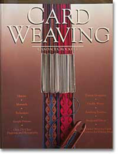 The image shows the cover of a book titled "Card Weaving" by Candace Crockett, published by Penguin Random House. The cover features an intricate weaving design with colorful weaving patterns on a loom, predominantly in shades of blue and red, showcasing this ancient craft.