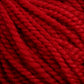 Close-up of several strands of thick, red Norumbega yarn from Caledonian Dye Works, made from 100% U.S. wool, showing their twisted texture and fibrous detail.