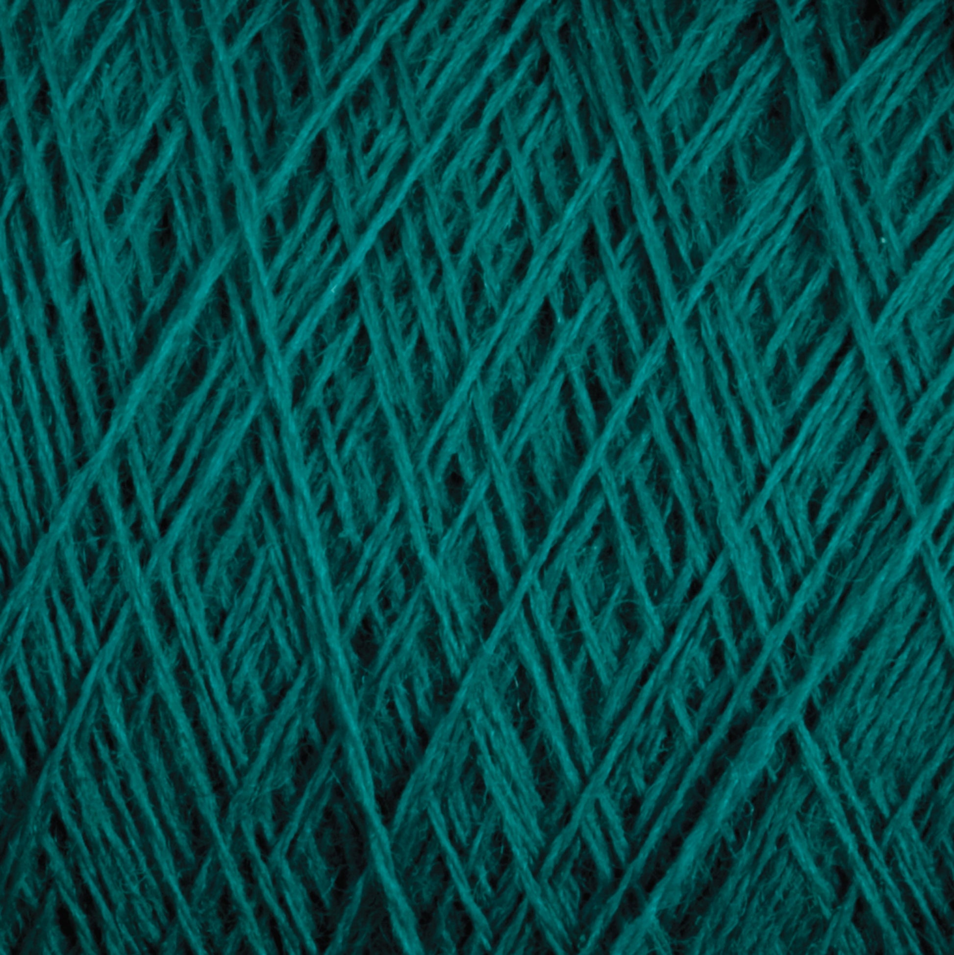 A close-up image of Jagger Brothers, Inc.'s JaggerSpun Maine Line 3/8 Yarn on a large cone, showcasing its detailed texture. The strands are intricately intertwined, creating a pattern of lines and fibers. This worsted spun yarn features rich teal shades with variations in shading due to its soft medium grade wool thickness and weave.