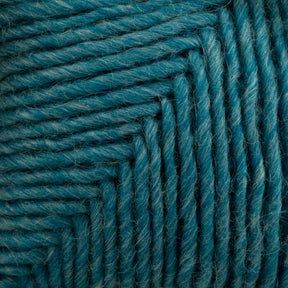 Close-up of tightly wound, teal-colored Lamb's Pride Worsted Yarn by Brown Sheep. The strands are neatly aligned and form a pattern with distinct lines and textures, showcasing the fiber's softness and slight fuzziness—perfect for felting projects.