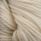 Close-up of thick, cream-colored Norumbega yarn by Caledonian Dye Works, showcasing the textured, twisted strands woven together. Made from 100% U.S. wool, the material appears soft and fluffy with a subtle sheen, creating a cozy and warm impression.