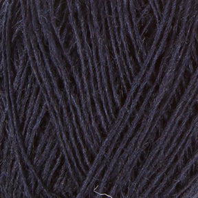 Close-up image of a ball of dark navy blue Einband Lopi yarn by Berroco, Inc., showing the texture and strands tightly wound together. The fibers appear slightly fuzzy, giving the yarn a soft and cozy appearance. Perfect for stranded colorwork projects that demand warmth and durability.