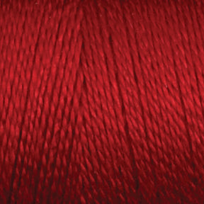 A close-up view of a spool of rich, vibrant 8/2 Bamboo Yarn in red from Maurice Brassard. The individual fibers are tightly wound, creating a smooth and uniform texture. Perfect for knitters seeking quality materials, this environmentally friendly mini-cone yarn highlights the fine details of its composition.