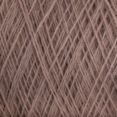 Close-up view of a ball of light brown JaggerSpun Maine Line 3/8 Yarn from Jagger Brothers, Inc. The yarn is tightly wound with visible overlapping strands, creating a textured and interwoven pattern. The fibers appear soft and slightly fuzzy, indicative of the natural or blended fiber composition typical of JaggerSpun yarns.