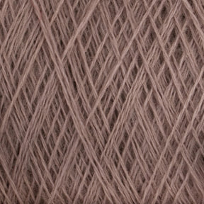 Close-up view of a ball of light brown JaggerSpun Maine Line 3/8 Yarn from Jagger Brothers, Inc. The yarn is tightly wound with visible overlapping strands, creating a textured and interwoven pattern. The fibers appear soft and slightly fuzzy, indicative of the natural or blended fiber composition typical of JaggerSpun yarns.