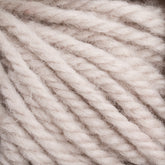 Close-up of beige, chunky yarn strands twisted together, showcasing the texture and fibers. The yarn appears soft and plush, suitable for knitting or crochet projects. The image highlights the natural and slightly fuzzy surface of the fibers, reminiscent of Halcyon Yarn Classic Rug Wool | Strand by Caledonian Dye Works used by rug weavers.