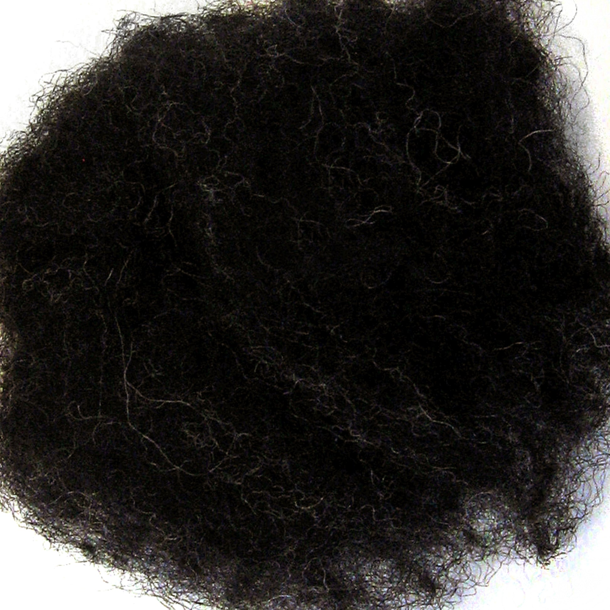 A close-up image of a dense, dark ball of steel wool set against a white background. The fibers are intertwined and create a somewhat messy appearance, with varying thickness and a textured surface reminiscent of Harrisville Designs' Harrisville Dyed & Carded Wool Fiber.