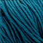 A close-up view of Plymouth Select Worsted Merino Superwash yarn from Plymouth Yarn Co. tightly wound into a ball. The teal-colored yarn strands exhibit clear texture, showing slight variations in thickness and a soft, fuzzy surface. The rich color and intricate weaving create a visually pleasing pattern with excellent stitch definition.