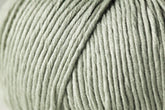 Close-up image of a skein of Jo Sharp Soho Summer DK Cotton by Kingfisher Yarn & Fibre, showcasing the neat, parallel arrangement of the light grey yarn strands. The texture appears smooth and soft, making it ideal for knitting or crocheting projects. Perfect for summer creations due to its lightweight cotton feel.