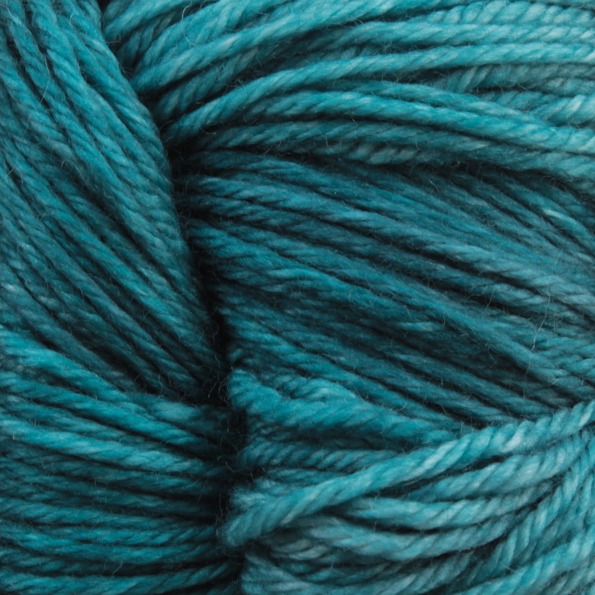 Close-up of Malabrigo Arroyo by Malabrigo Yarn in teal blue, a sport weight superwash merino wool yarn, showing twisted and intertwined strands with a soft, woolen texture, perfect for lightweight garments.