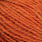 A close-up image of the thick, orange Harrisville Highland - Cones yarn by Harrisville Designs. The texture is visible, showing individual fibers and strands twisted together. The overall color is a warm, rusty orange with subtle variations in hue throughout the unscoured yarn.