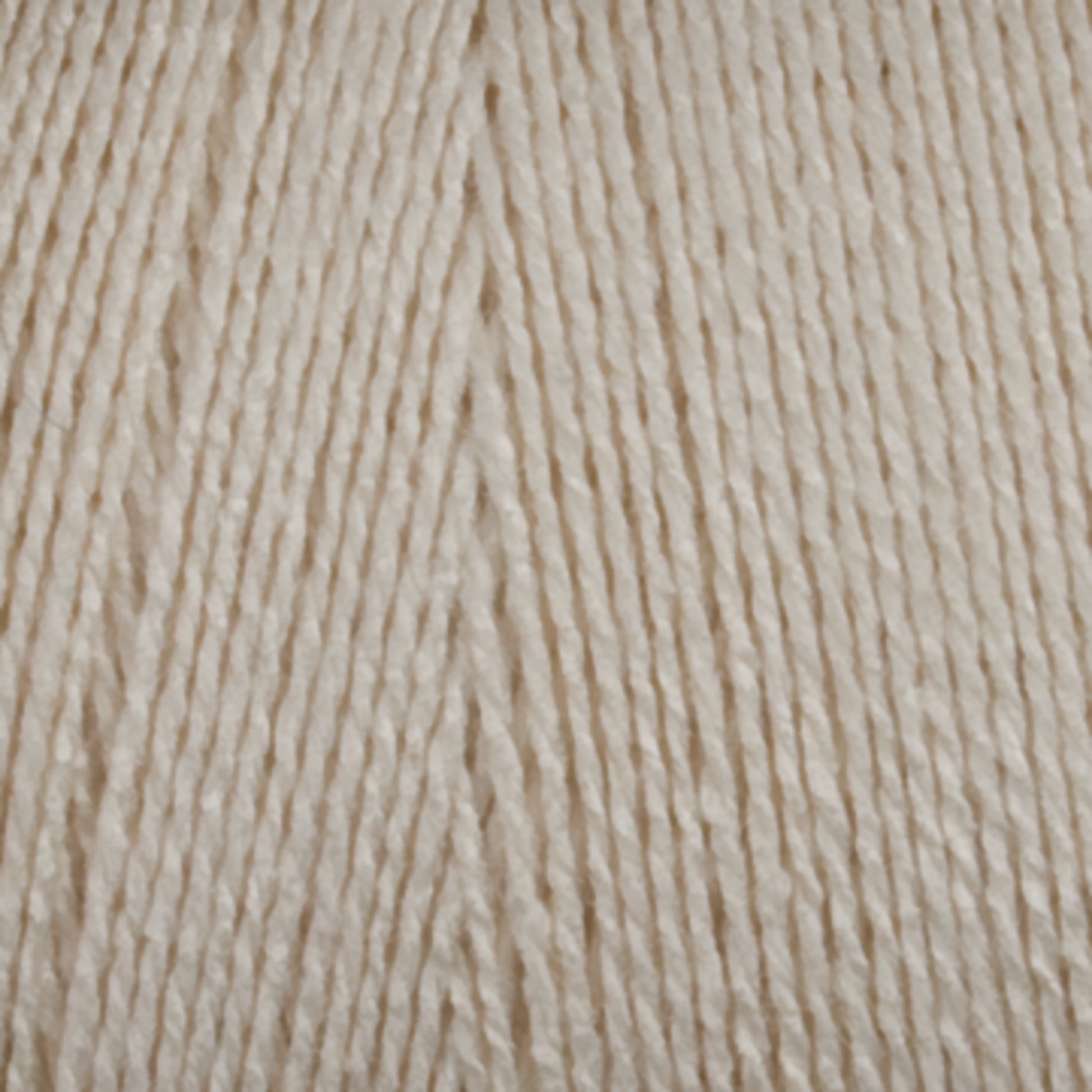 A close-up image showcases Maurice Brassard's 16/2 Bamboo Yarn in beige. The tightly wound strands reveal a smooth and even texture, capturing the fine details of the fibers. This image highlights the yarn's soft, delicate, and sustainable qualities, making it an excellent choice for knitting or crocheting projects.