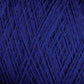 Close-up image of deep blue JaggerSpun Maine Line 3/8 Yarn by Jagger Brothers, Inc., wound into a ball, displaying an intricate crisscross pattern of the strands. The texture appears soft and slightly fuzzy.