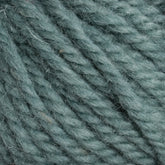 Close-up of Halcyon Yarn Classic Rug Wool in teal. The texture is soft and woolly, with individual fibers clearly visible. Thick strands are twisted together, giving it a textured and cozy appearance—perfect for rug weavers employing hand-dye techniques to create masterpieces with Caledonian Dye Works' premium product.