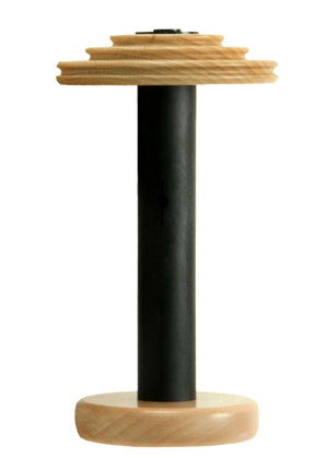 The Louët S10 & S15 Bobbin for Irish Tension (bobbin lead) wheels by Louët Inc. is showcased against a white background, highlighting its wooden and black metal design with a circular wooden base, a tall black cylindrical shaft, and a tiered wooden top.