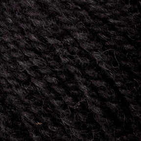 Close-up of dark, textured fibers resembling Bartlettyarns Maine Wool Yarn or knitted fabric, densely woven together with a soft, fuzzy appearance. The image showcases heathered colors in shades of black and gray, reminiscent of Bartlettyarns.