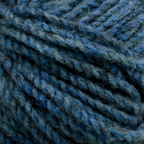 Close-up of blue and gray yarn fibers twisted together in a tightly wound skein. The Briggs & Little Tuffy Canadian Sock Yarn has a soft and slightly fuzzy texture, showcasing various shades of blue with hints of gray, perfect for knitting warm winter socks and creating a rich, textured appearance.