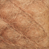 Close-up texture of Caledonian Dye Works' Victorian Brushed Mohair Yarn in a Mini Skein, showcasing its fibrous, reddish-brown material that resembles luxurious mohair or densely packed natural fibers with an intertwined and slightly tangled appearance.